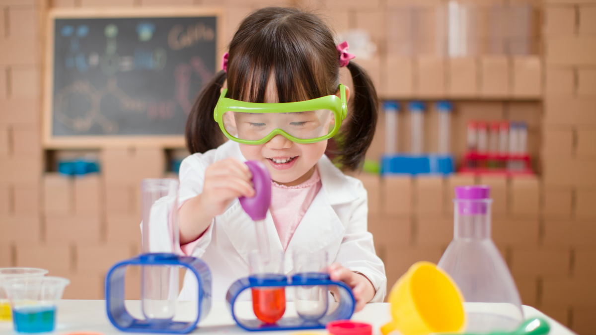 toddler girl plays science experiments